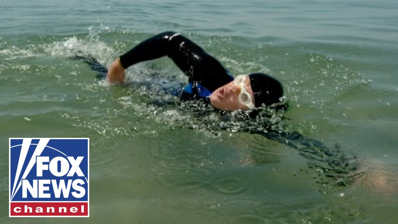 SWIMMING FOR AMERICA'S HEROES: Towing 250 cannonballs across Lake Michigan