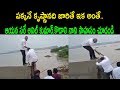 Kodali Nani helps Anil to climb Krishna river bund in flood-hit Vijayawada