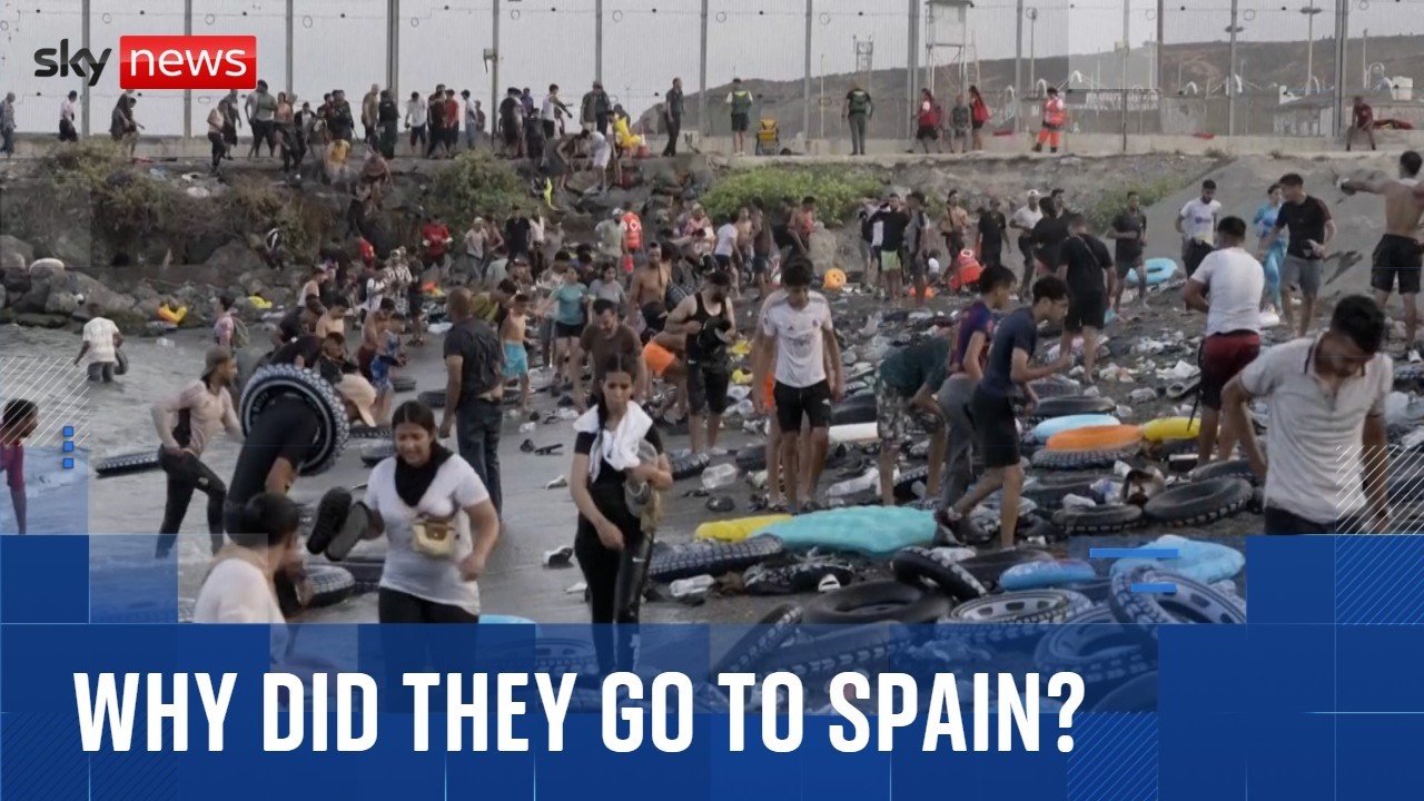 Why did tens of thousands of migrants cross Morocco's border into Spain?