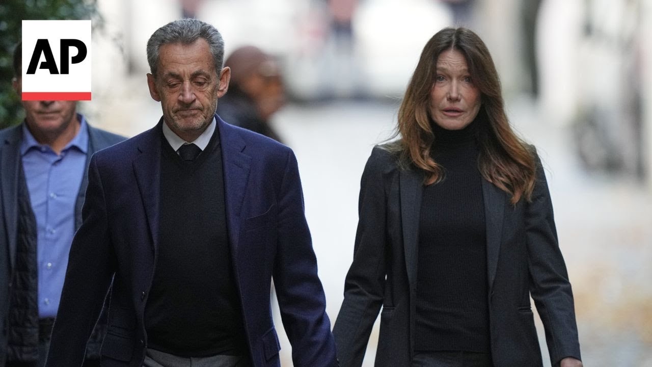 Former French President Nicolas Sarkozy greets supporters before heading to prison