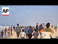 Hundreds gather in southern Gaza Strip trying to get aid airdropped onto the enclave