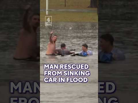 Moment driver rescued from a sinking car in Australian flood