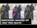 Woman swept away by tide in front of her children while taking pic with husband