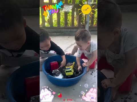 Bé yêu nghịch cát vui vẻ