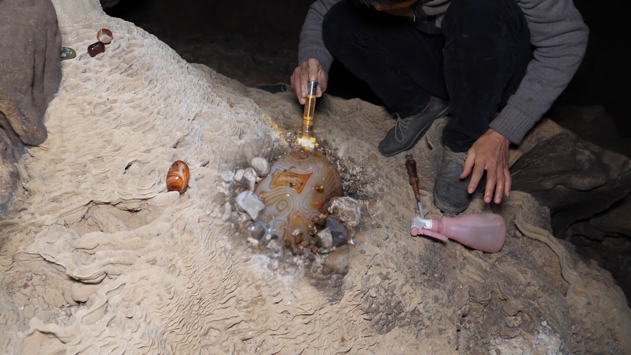 The man used special tools to dig out such a large crystal gem.