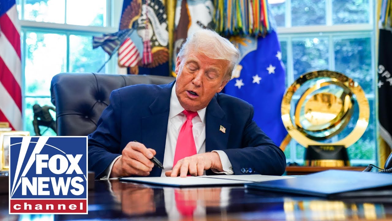 President Trump signs an executive order in the Oval Office