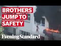 Two boys jump off building to escape massive fire, video goes viral