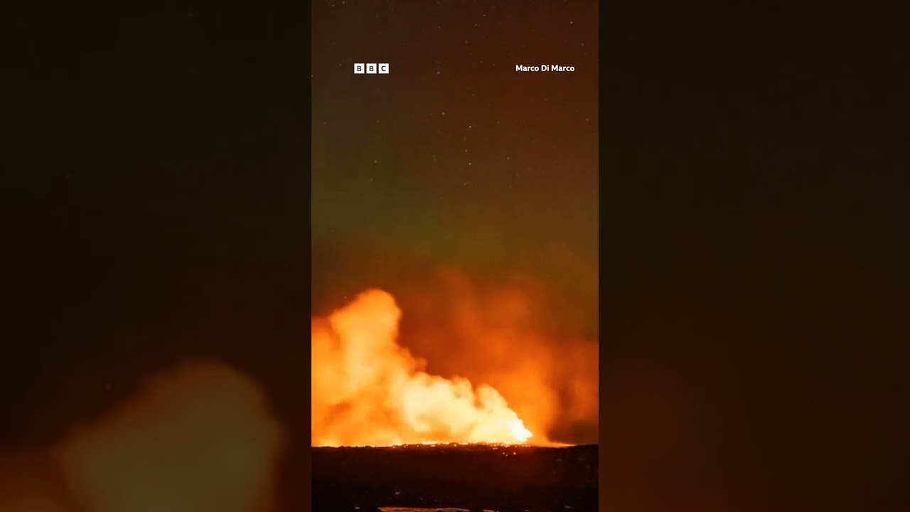 Northern Lights captured glowing over erupting Iceland volcano. #Shorts #Grindavik #BBCNews