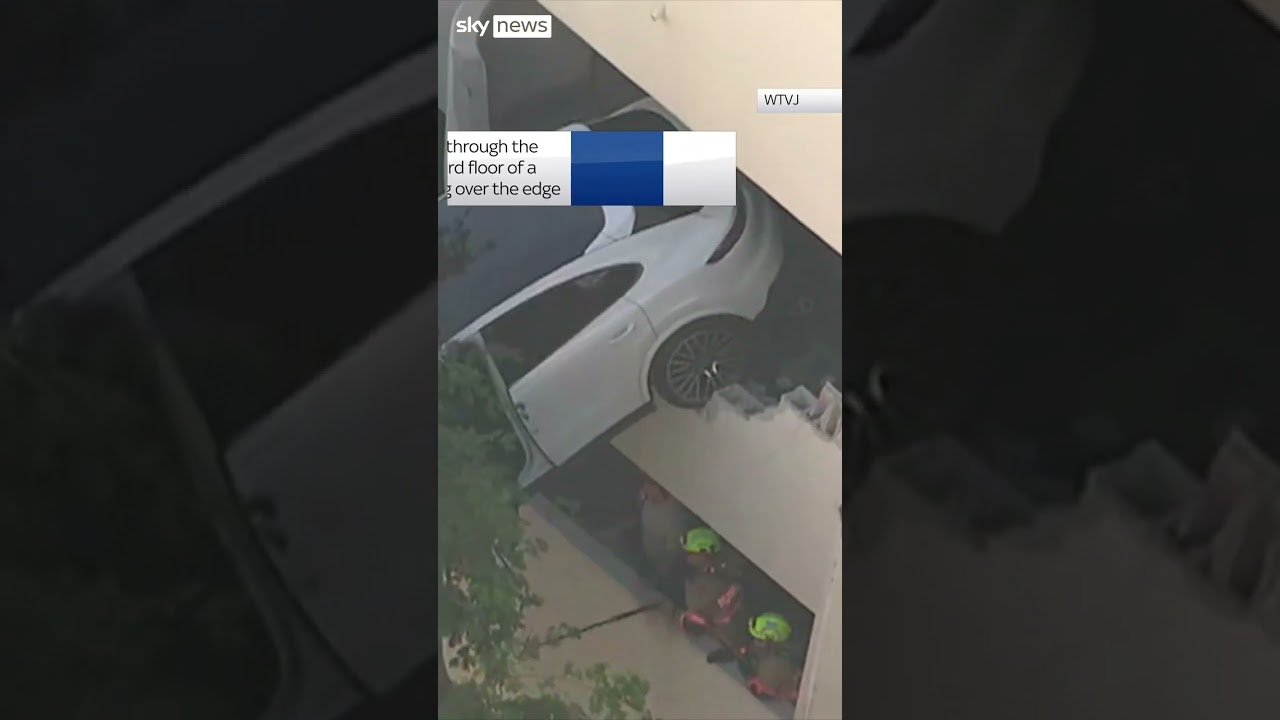 Woman saved from dangling car