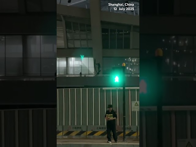 Moment: A security guard dances to a song outside Kanye's concert in Shanghai