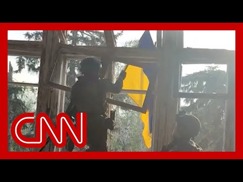 Ukrainian soldier raises flag in newly liberated village