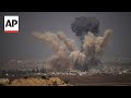 Multiple explosions send huge plumes of smoke into the sky over Gaza