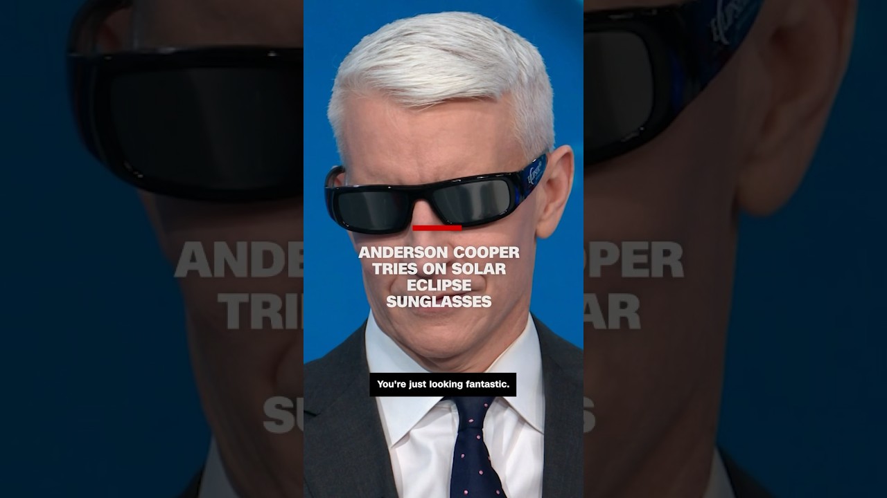 Anderson Cooper tries on solar eclipse sunglasses