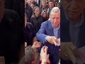 Tayyip Erdogan hands cash to supporters at polling station