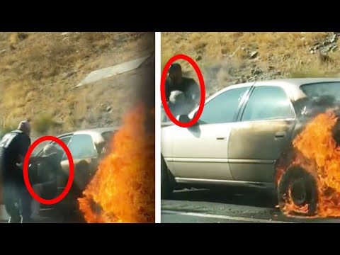Elderly couple pulled from burning car by group of men Elderly couple pulled from burning car by group of men
