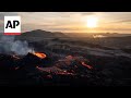 Iceland volcano spews lava as partial eclipse is visible