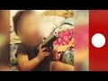 Mobile footage: Baby plays with real gun, encouraged by neglectful parents, USA