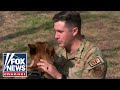 COULDNT BE HAPPIER: Service member reunites with military working dog