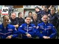 US-Russian crew aboard Soyuz spacecraft dock at International Space Station