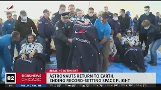 Astronauts return to Earth, ending record-setting space flight