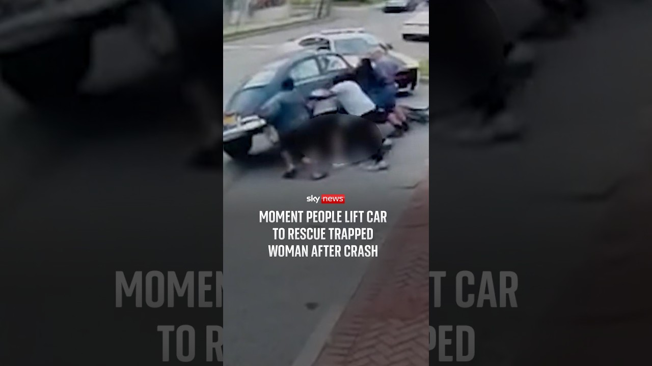 Moment people lift car to rescue trapped woman after crash