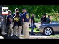 Authorities seen investigating the home of Charlie Kirk shooting suspect