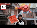 Taiwanese buy Dragon New Year couplets and flowers on the eve of Lunar New Year