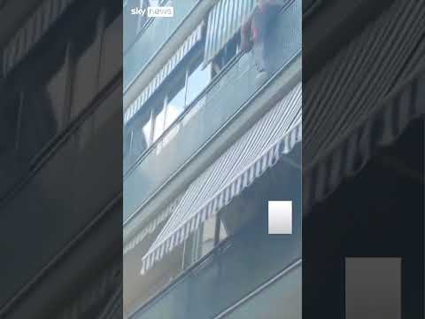 Bricklayer rescues boy hanging over balcony