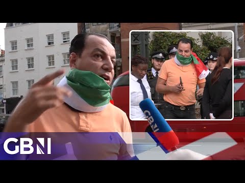 'I'm not bothering anyone!' | Man wearing Palestinian flag removed from outside Israeli Embassy