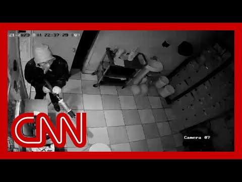 Surveillance footage shows hero confronting suspected gunman
