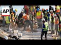 Rescuers search for missing dozens after building collapse in South Africa