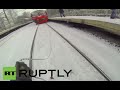 RT-Skiing: Crazy Russian daredevil ties himself to speeding train