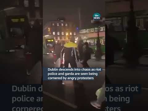 Dublin descends into chaos as riot police and garda are seen being cornered by angry protesters