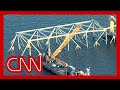 Cleanup crews maneuver to clear Baltimore bridge collapse wreckage