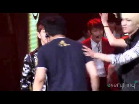 Onew being carried off stage by a PD LOL