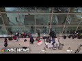 Migrants shelter inside Bostons Logan International Airport