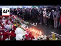 Mourners lay flowers for the victims at the site of terror attack in Moscow