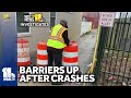 Crews install temporary barriers to alley
