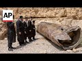 Jewish Ultra-Orthodox families inspect debris of whats believed to be an intercepted Iranian surfac