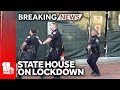 Police converge on State House with guns drawn
