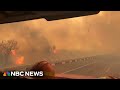 WATCH: Texas firefighters drive along highway surrounded by wildfire