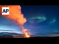 Timelapse shows Northern Lights shinning over erupting Iceland volcano