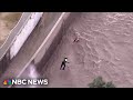Video shows woman plucked from Los Angeles River during Spring storm