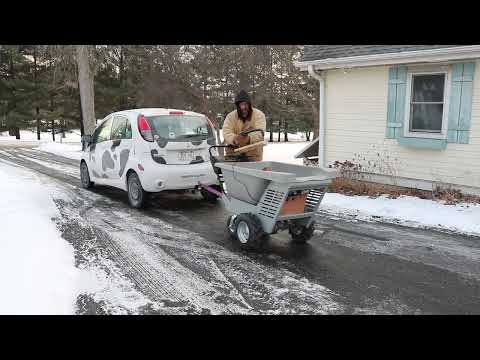 Electric wheelbarrow tows car up driveway