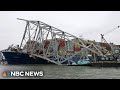 Workers create narrow channel through destroyed Baltimore bridge