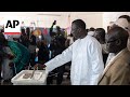 Senegal votes in tight presidential race after months of unrest