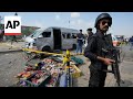 Police at scene after suicide attack in Karachi which Japanese autoworkers narrowly escaped