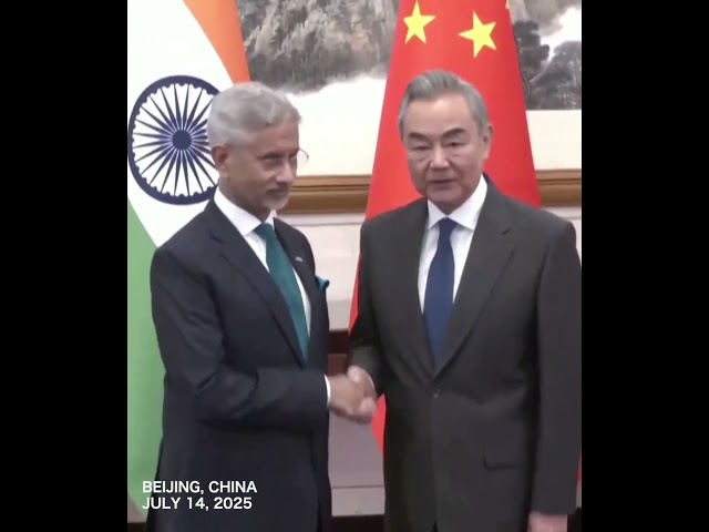 China's foreign minister Wang Yi shaking hands with his Indian counterpart in Beijing