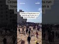 Crowds of Palestinians run toward aid trucks  - 00:34 min - News - Video