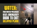 Watch: Frustrated passenger uses emergency door to exit delayed plane